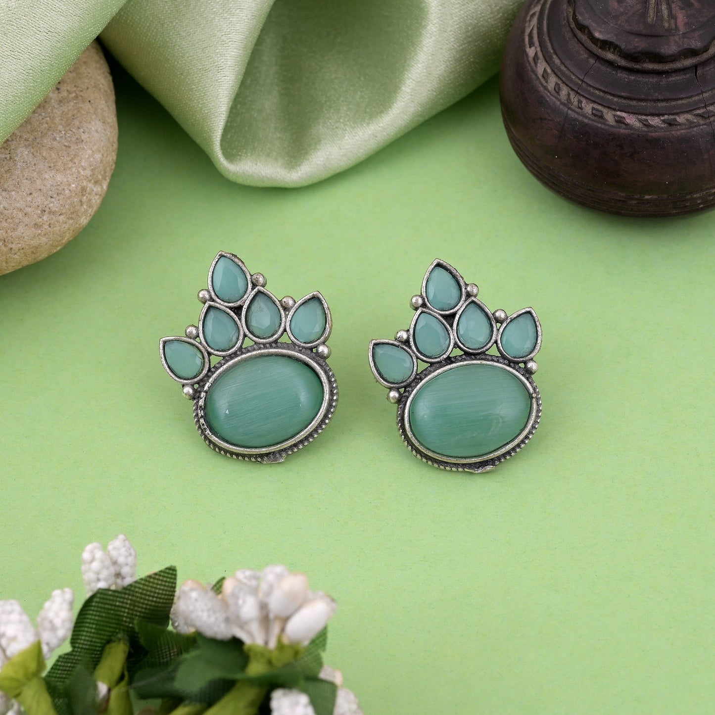 Charming Pista Green Color Oxidised Earrings With Floral Carving Design