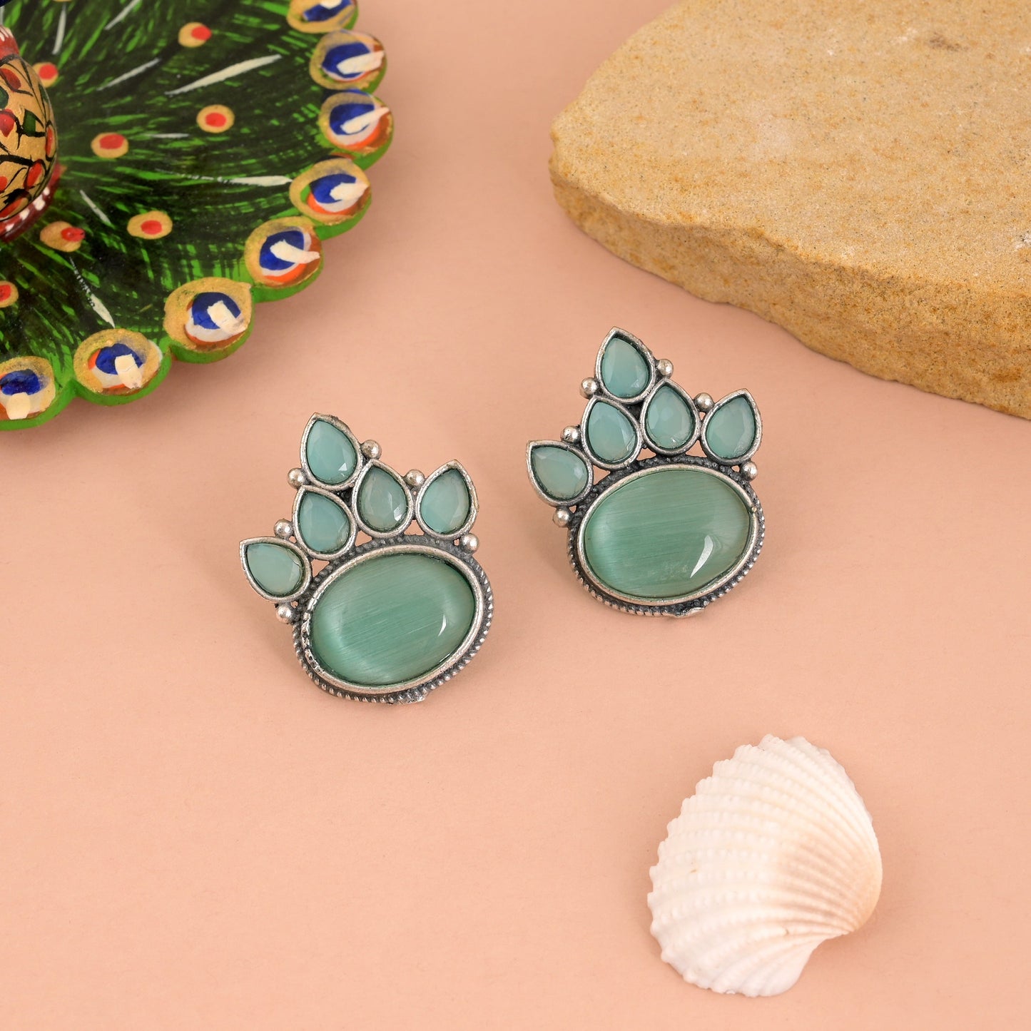 Charming Pista Green Color Oxidised Earrings With Floral Carving Design