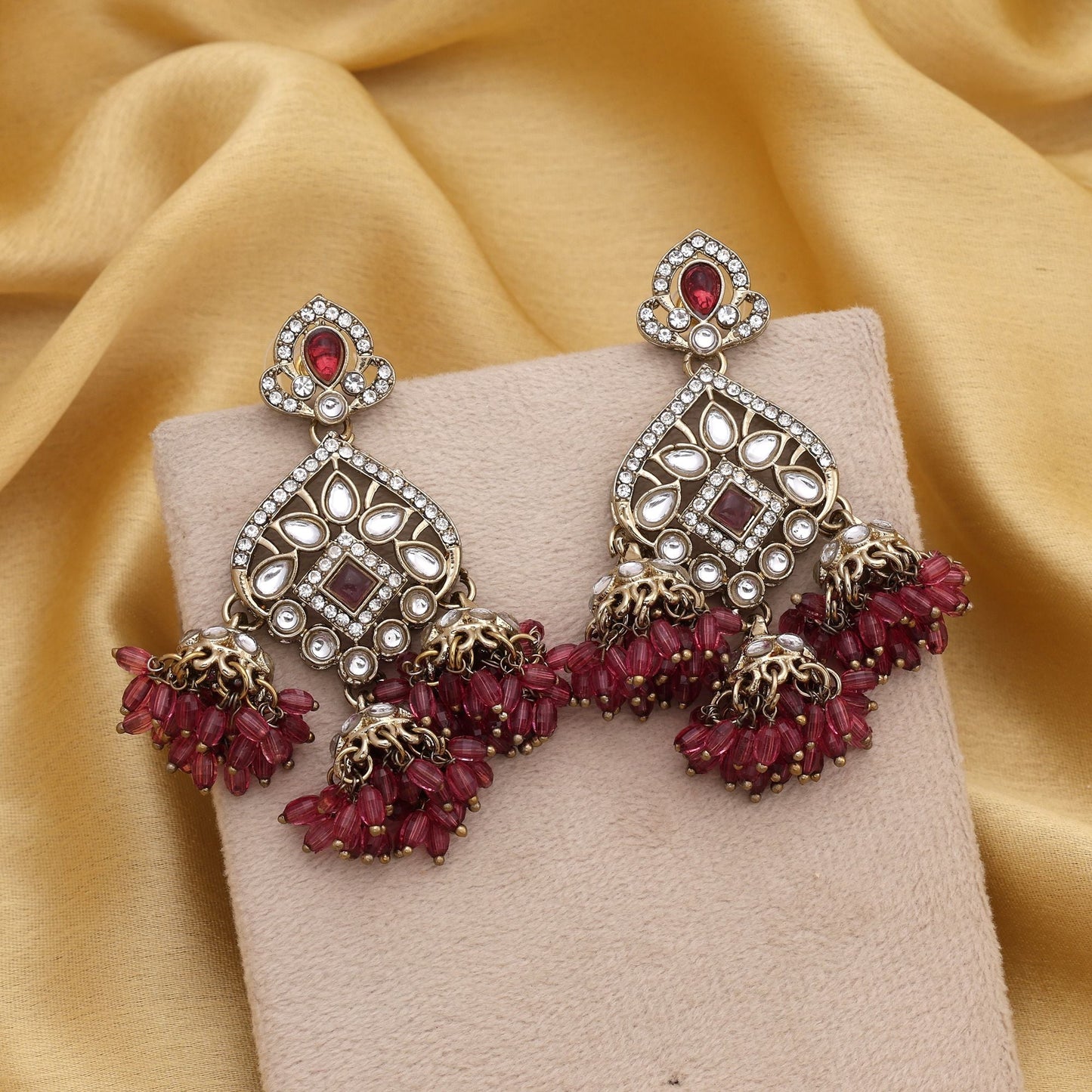 Eye-Catching Magenta Color Kundan Earrings With Floral Pattern For Festive Events