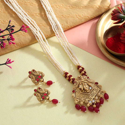 Alluring Rani Color Matte Gold Necklace Set With Handcrafted Antique Work And Pearl Detailing