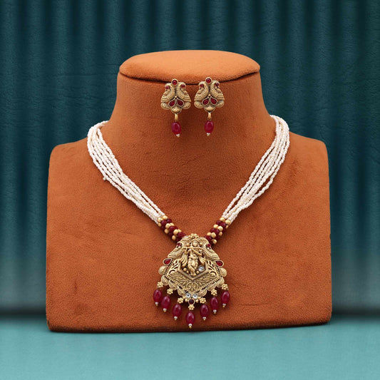 Alluring Rani Color Matte Gold Necklace Set With Handcrafted Antique Work And Pearl Detailing