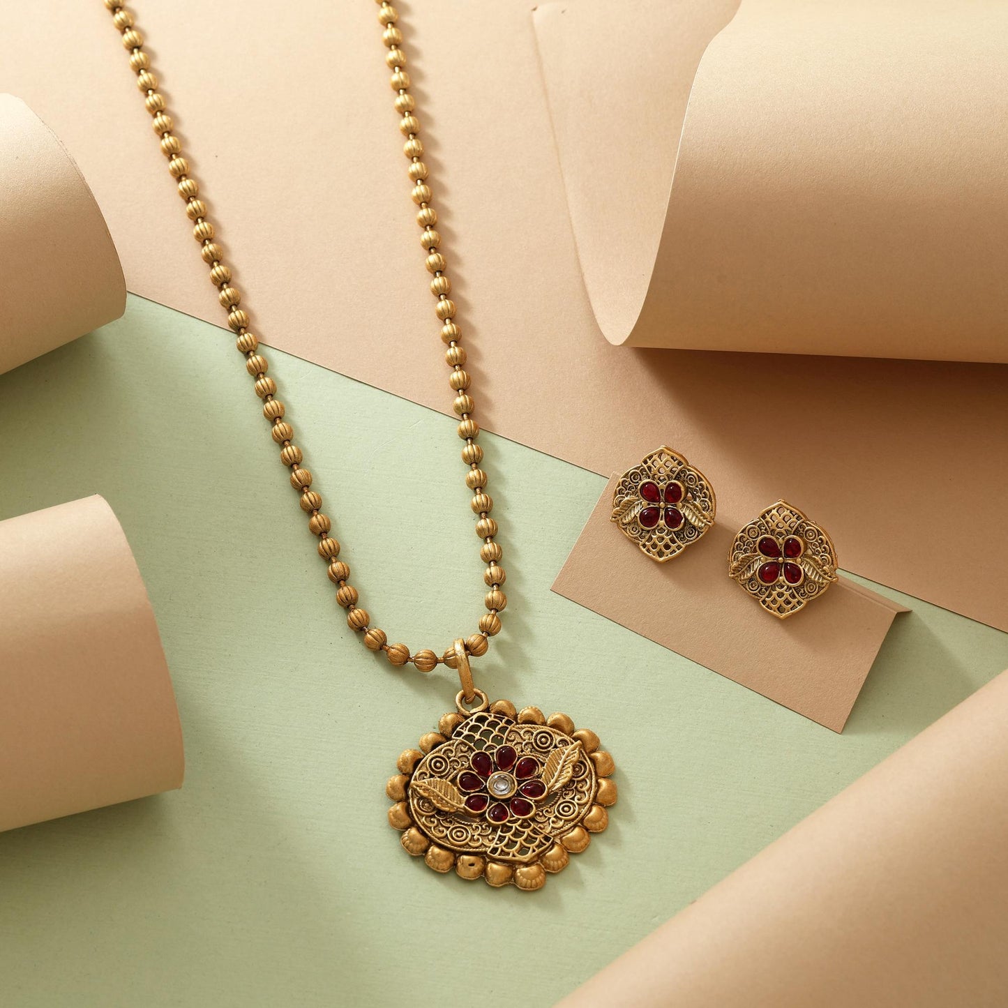Beautiful Rani Color Matte Gold Necklace Set With Classic Floral Patterned Pendant Design