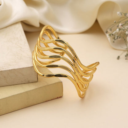 Goldfarbenes Armband, kreiert mit kunstvollen Details, um festliche Looks mit strahlendem Glanz zu unterstreichen