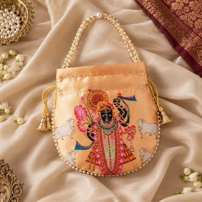 Charming Peach Color Pearls Shree Nath ji Handwork Silk Potli Bag For Brides